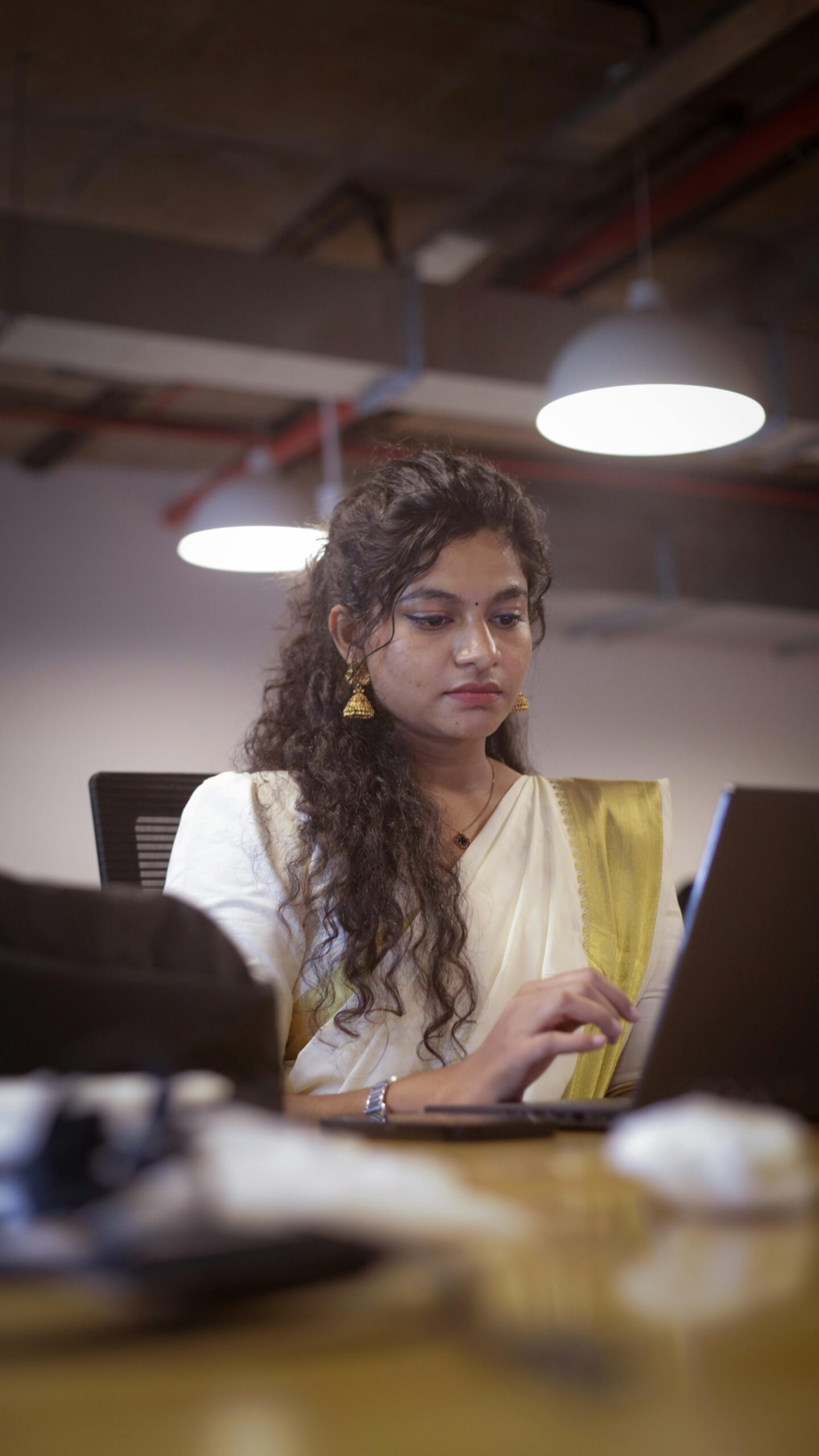 Beautiful south indian brown woman with curly hair at office
